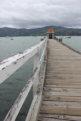 A long jetty at Akaroa on the Banks peninsula, Christchurch, New Zealand. 
