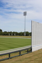 A light tower and sight screen associated with a cricket ground in Christchurch, New Zealand.  - obrazy, fototapety, plakaty