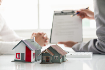 Fototapeta premium Real estate brokers are offering sample homes for customers choose from and recommending estate insurance promotions help protect their properties. Concept of offering real estate and home insurance