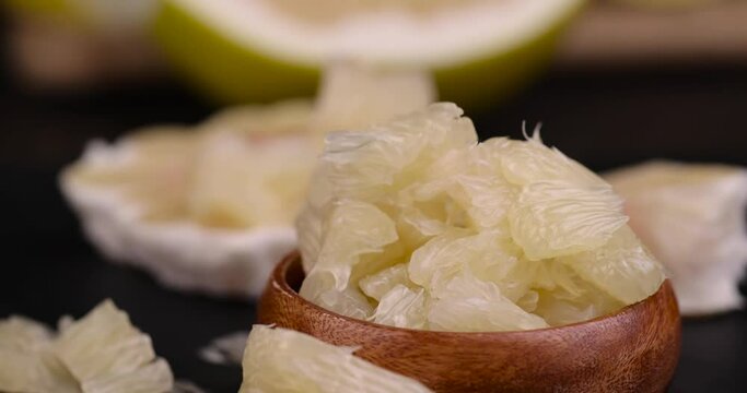 Chunks of ripe pomelo close-up, fresh fruit pomelo ready to eat