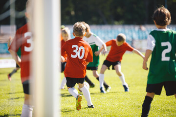 Group of School Boys Play Soccer Football Match With Friends. Youth Professionals Soccer Kids...