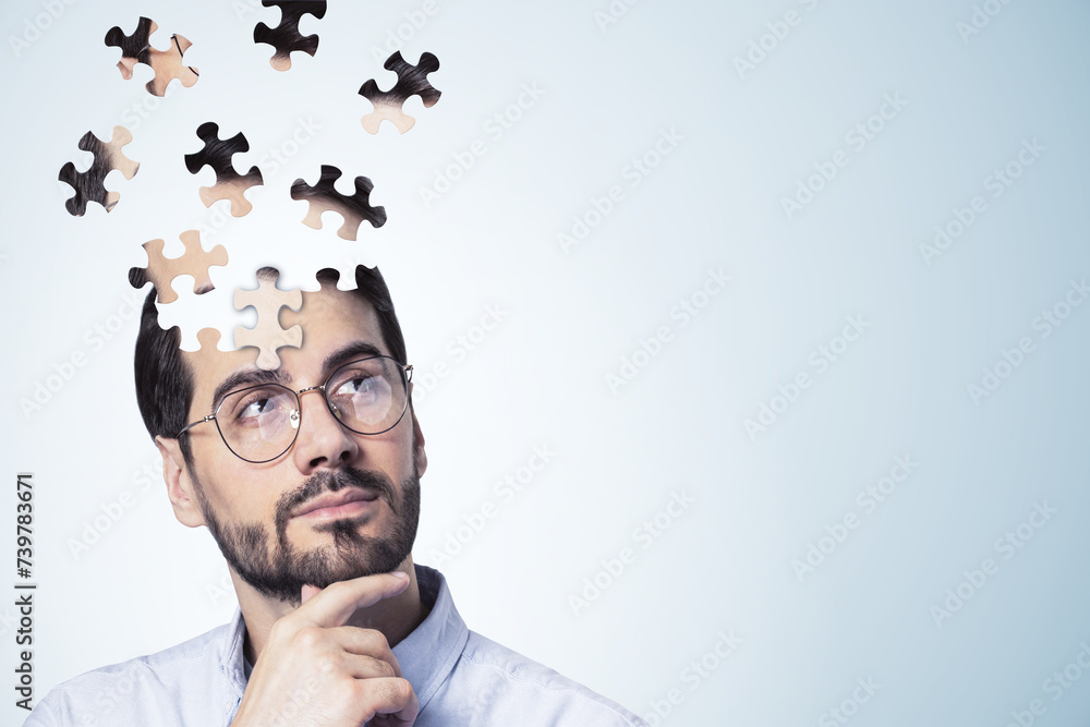 Aufkleber Puzzle headed thoughtful businessman portrait on light background with mock up place. Solution, decision and brainstorm concept.