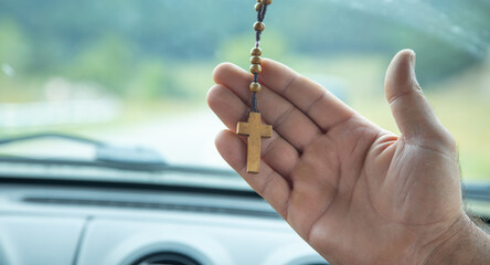 Human hand showing christian cross.