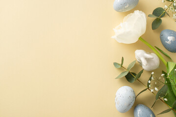 Seasonal elegance captured with top view of slate grey eggs, a bunny sculpture, gypsophila, tulip,...
