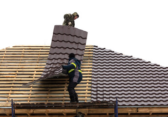 Workers install tiles on the roof of a house in winter