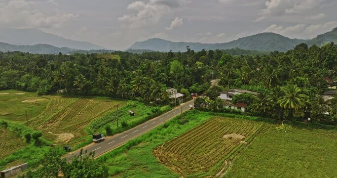 Matale Sri Lanka Aerial v4 cinematic drone flyover vast ploughed farmlands along AB26 road capturing residential suburbs and hillside mountain landscape - Shot with Mavic 3 Cine - April 2023