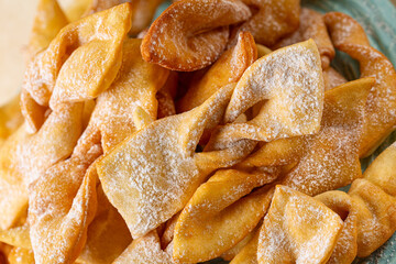 Close up of Angel wings or bugnes, bugie, or chvorost; faworki. Traditional sweet crisp pastry...