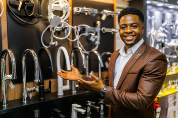 Portrait of salesperson in bathroom store. Happy man works in bath store. Sales occupation.