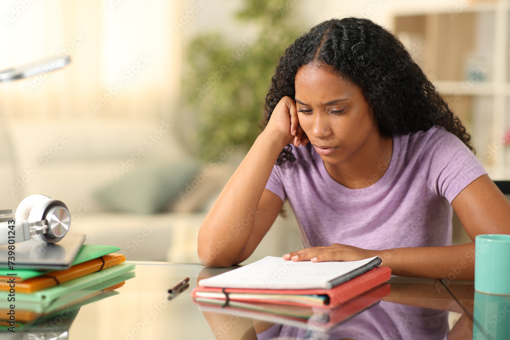 Wall mural black student studying memorizing notes at home