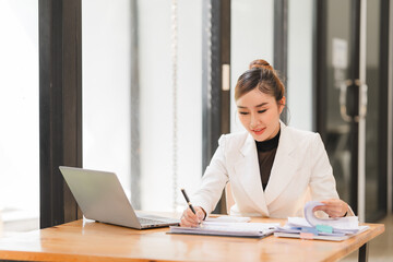 Asian businesswoman use laptop computer in office The Internal Revenue Service audit document...
