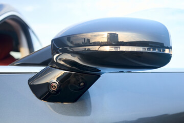 Luxury car detail left back mirror two parking cameras closeup. Road safety concept. 360 terrain...