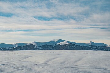 Fototapeta na wymiar winter mountain landscape and cloudy sky