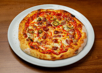 Mexican pizza with jalapenos on a plate.