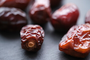 Dried dates are laid out slate board.