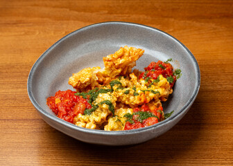 Cheese fried in batter with tomato sauce in a plate.