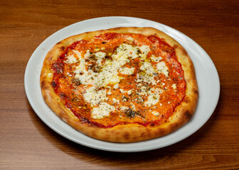 Italian pizza four cheeses on a plate.