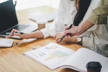 Close-up photo of businessman's hands signing documents at desk, man at work in business suit