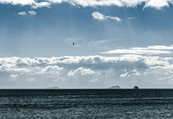 Fototapeta na wymiar A cloudy weather at the horizon and a ship