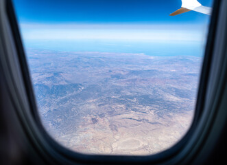 Fototapeta premium Plane Window View, Aircraft Fly Landscape, Looking from Plane Cabin, Plane Window Aerial View