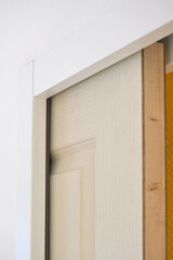 Pocket door in a white plasterboard wall (sliding door inside a wall)