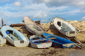 old fishing boats on the shore against the background of clouds
