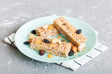 Various granola bars on table background. Cereal granola bars. Superfood breakfast bars with oats, nuts and berries, close up. Superfood concept