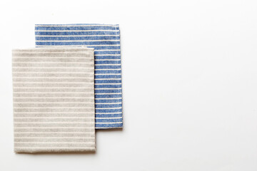 top view with gray kitchen napkin isolated on table background. Folded cloth for mockup with copy...
