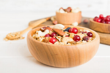 Cooking a wholesome breakfast. Granola with Various dried fruits and nuts in a bowl. The concept of a healthy dessert. Flat lay, top view with copy space