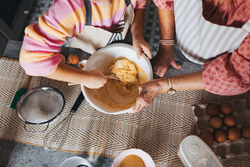 Top view of cake batter. Grandmother with grandaughter preparing traditional easter meals, baking cakes and sweets. Passing down family recipes, custom and stories.
