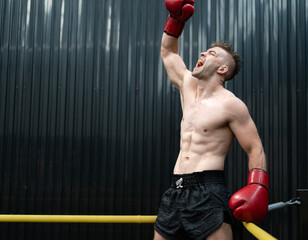 Male athlete boxing competition in ring. Caucasian ethnic man punch fighting in kickboxing exercise...