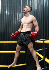 Male athlete boxing competition in ring. Caucasian ethnic man punch fighting in kickboxing exercise...