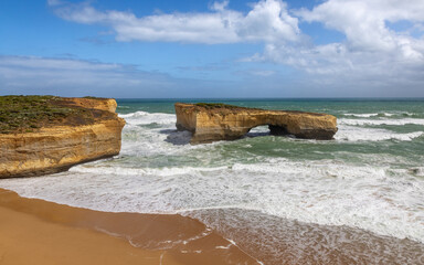 The London Bridge rock formation on the Great Ocean Road, Port Campbell National Park, Australia. The stone stacks were connected until 1990, forming a double arch bridge. - 739833807