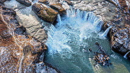 Godafoss waterfall overhead drone view.  One of the most spectacular waterfalls in Iceland with a horseshoe span of over 30 metres. Small unidentifiable people show scale. - 739834062