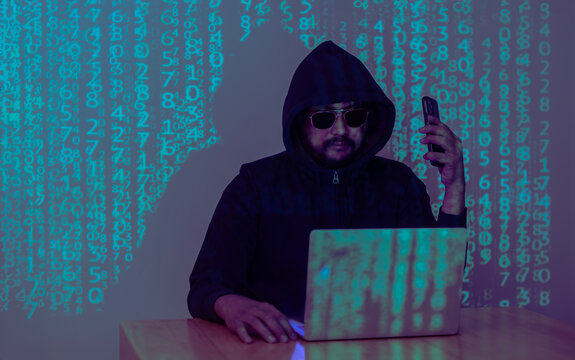 A hacker uses a malware with mobile phone and laptop to hack password the personal data and money