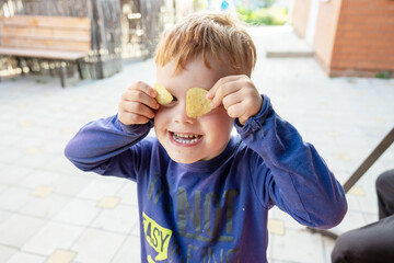 little boy made eyes out of chips
