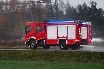A firetruck rushes to the scene of a fire. The firefighters on board are prepared to save lives and...