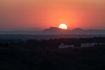 Majestic Sunset Over Rolling Hills With Silhouetted Landscape in the Foreground