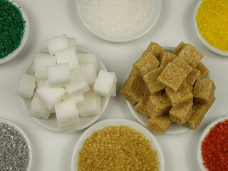 Different kinds of sugar, white, brown, and  colored sugar. 