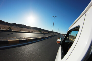 Asphalt road travel. White transportation bus perspective. Long road through desert. Egypt travel...