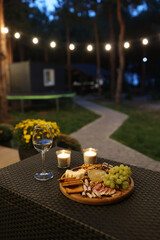 a picnic with wine in the evening on the terrace. romantic dinner with candles and wine