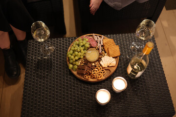 a picnic with wine in the evening on the terrace. romantic dinner with candles and wine