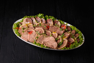 sliced meat on a black wooden background