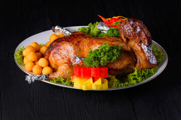 roast duck on a black wooden background