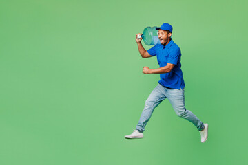 Fototapeta na wymiar Full body fun delivery guy employee man wear blue cap t-shirt uniform workwear work as dealer courier hold big large clear water bottle jump high isolated on plain green background. Service concept.