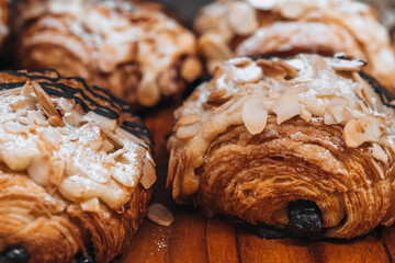 Sweet crispy fresh croissants with almonds - obrazy, fototapety, plakaty