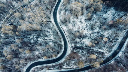 Aerial view of winding mountain road in winter.