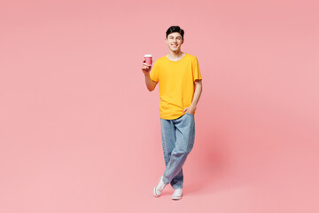 Full body young man he wears yellow t-shirt casual clothes hold takeaway delivery craft paper brown...