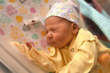 Newborn baby. A newborn baby lies in the maternity hospital.