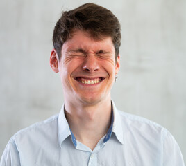 Fototapeta premium Portrait of young smiling guy in studio