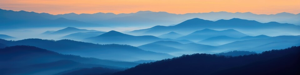 Fototapeta premium Great Smoky Mountain Ridge at Sunset: Stunning Blue and Orange Color Palette with Fog Over Country